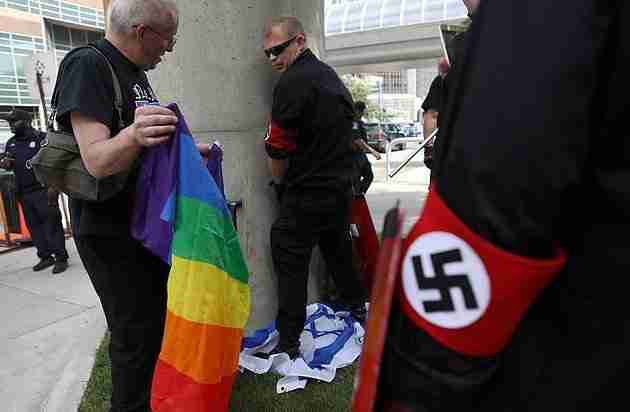A member of the NSM urinates on an Israeli flag during a Pride march in Detroit